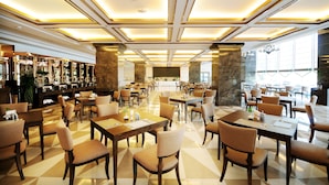 A spacious hotel lobby with multiple dining areas, a bar, and a reception desk. - Chengdu Airport Jianguo Hotel (Chengdu)