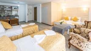 A hotel room with two beds, a dining area, and a kitchenette. - Grand Villa Sol Apart (Marmaris)