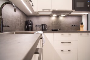 Apartamento luxo, 2 quartos, cozinha | Cozinha privada | Geladeira, micro-ondas, cooktop, lava-louças