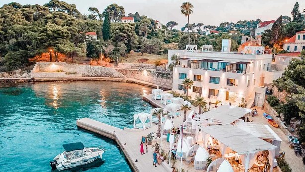 A coastal hotel with a pool, outdoor seating, and a view of the sea. - Kalamota Beach House (Dubrovnik)