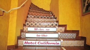 A staircase with a sign reading "Welcome to the Hotel California." - Hotel California (Zürich)