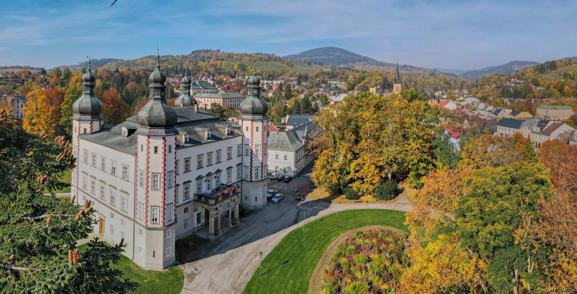 A large historic building with multiple towers and a central courtyard.