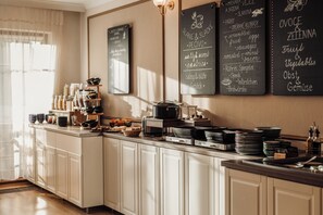 A kitchen with a chalkboard menu listing breakfast items. - Wellness Hotel Gendorf (Vrchlabi)