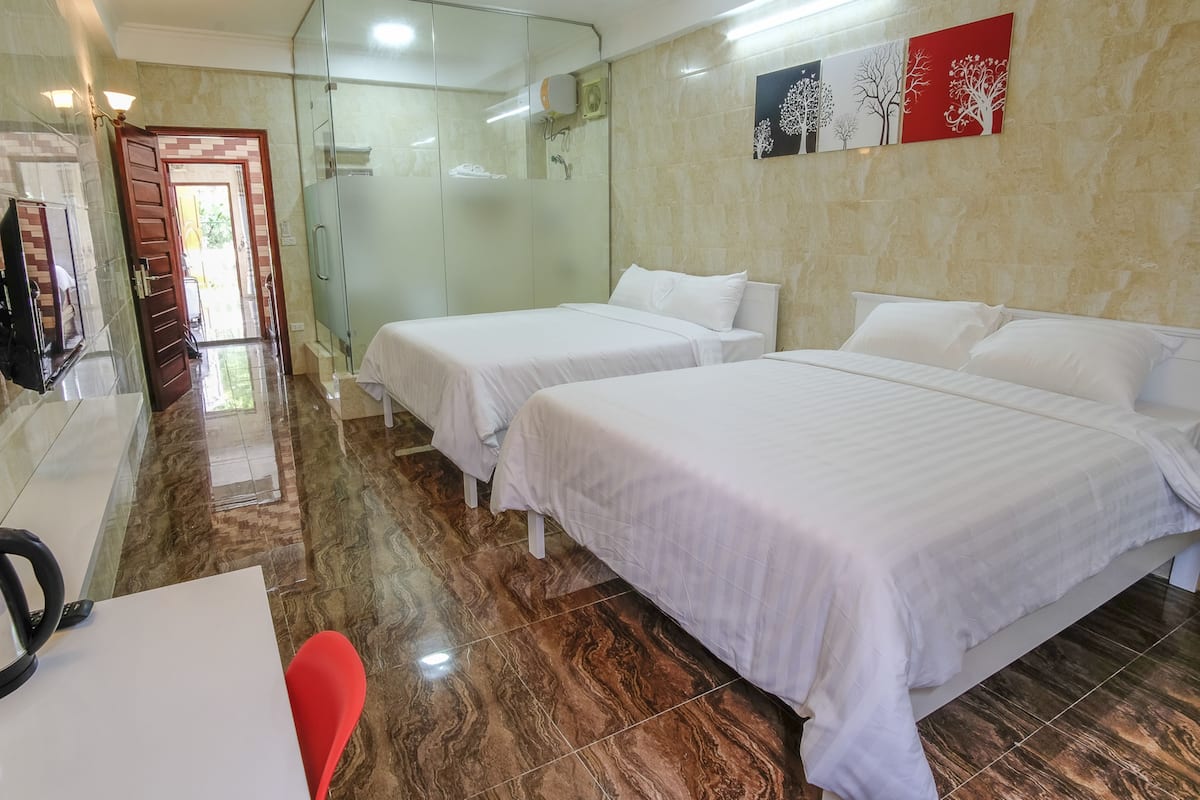 Family Room, 2 Queen Beds | In-room safe, desk, free WiFi, bed sheets