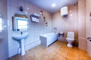 Standard Quadruple Room, 1 Bedroom | Bathroom | Shower, free toiletries, hair dryer, slippers