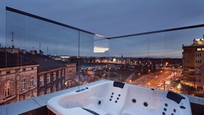 A hot tub with a city view, glass walls, and a wooden floor. - Aparthotel Best Views Luxury (Kraków)