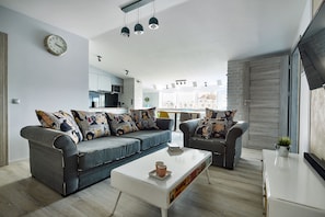 Deluxe Apartment, 2 Bedrooms (Modern) | Living area | 42-inch flat-screen TV with cable channels, TV