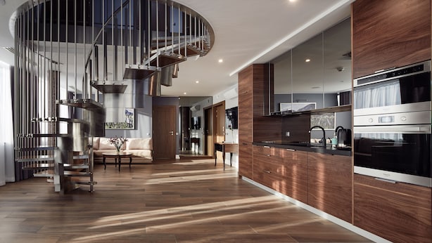 A modern kitchen with a built-in oven, a wooden cabinet, and a stainless steel range hood. - Aparthotel Best Views Luxury (Kraków)