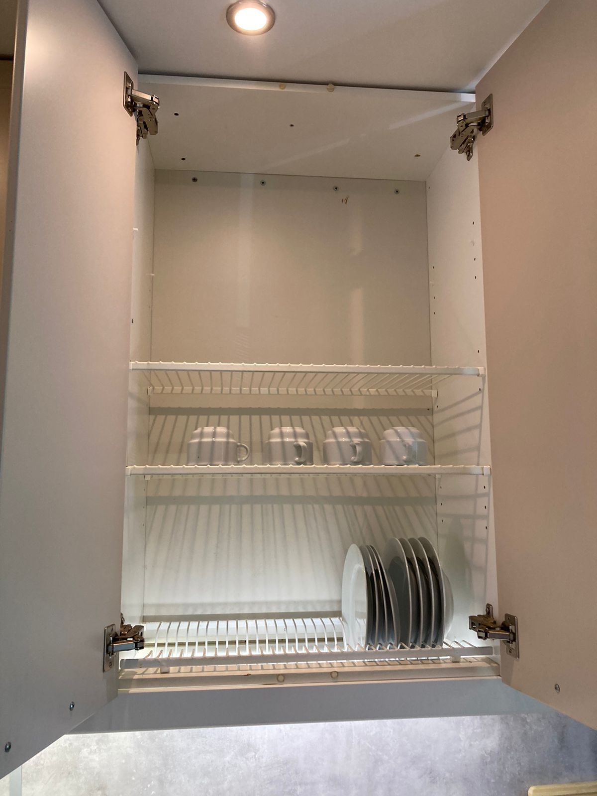 A kitchen with white cabinets and a built-in dishwasher.