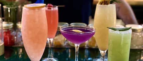 A bar with various cocktails in different glasses.