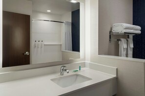 A bathroom with a white sink, a mirror, a towel rack, and a shower curtain. - Fairfield Inn & Suites by Marriott Indianapolis Fishers (Indianapolis)