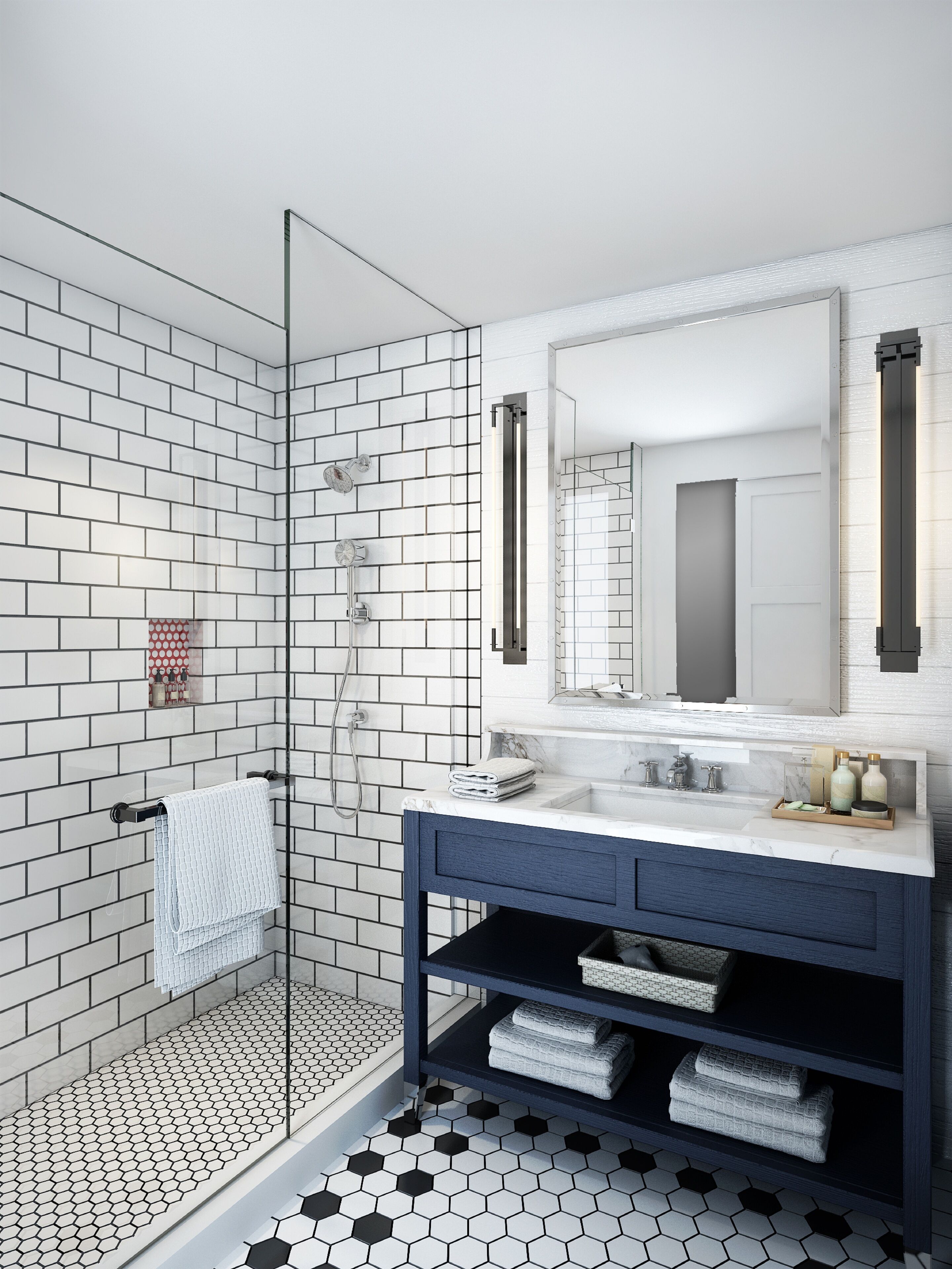 A modern bathroom with a glass shower enclosure, white subway tiles, a marble countertop, and a dark blue vanity.