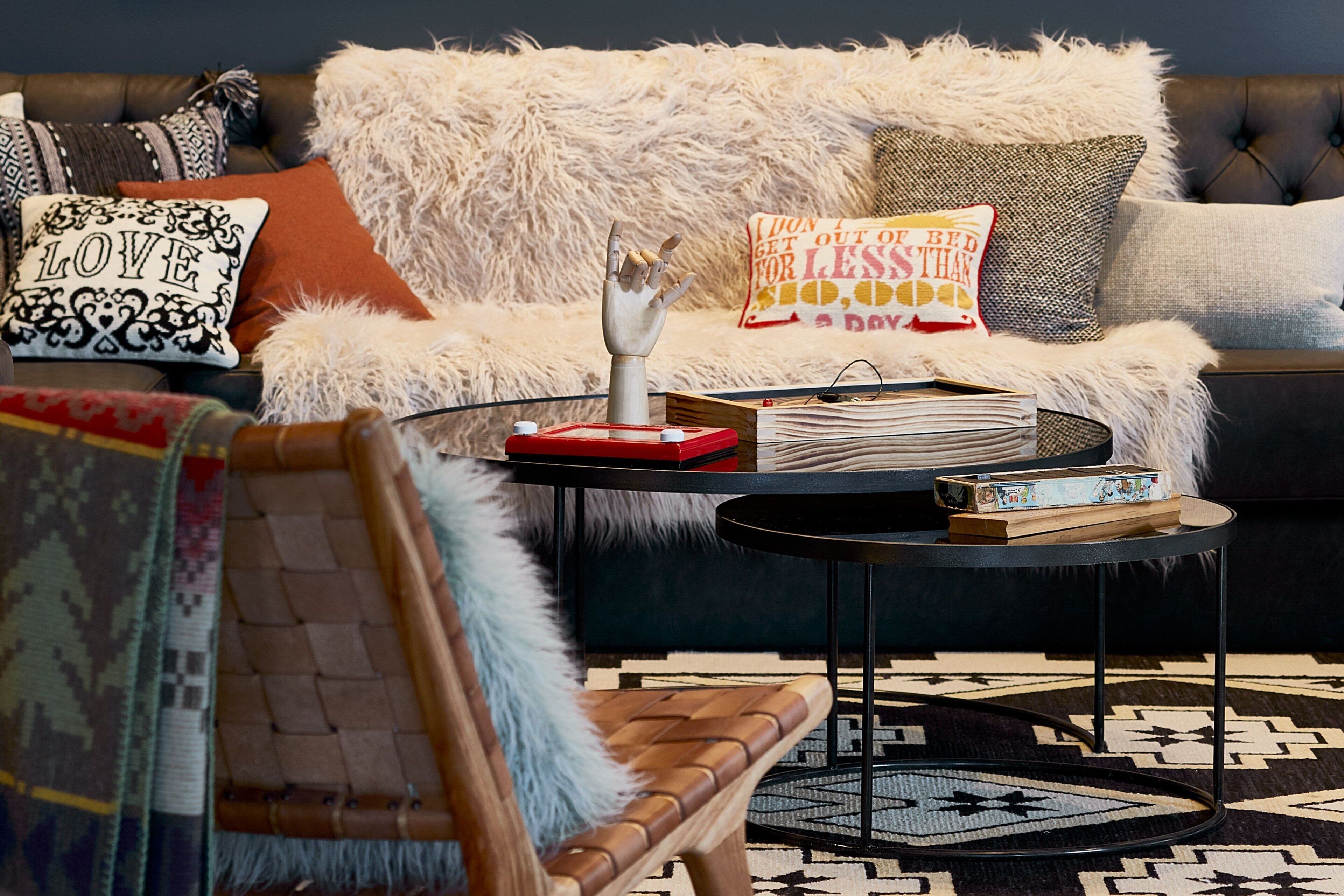 A cozy living room with a sofa, a coffee table, and a patterned rug.