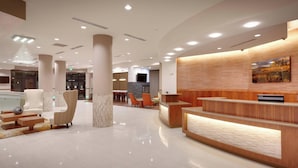 A modern hotel lobby with a reception desk, seating area, and a large chandelier. - Residence Inn by Marriott Flagstaff (Flagstaff)