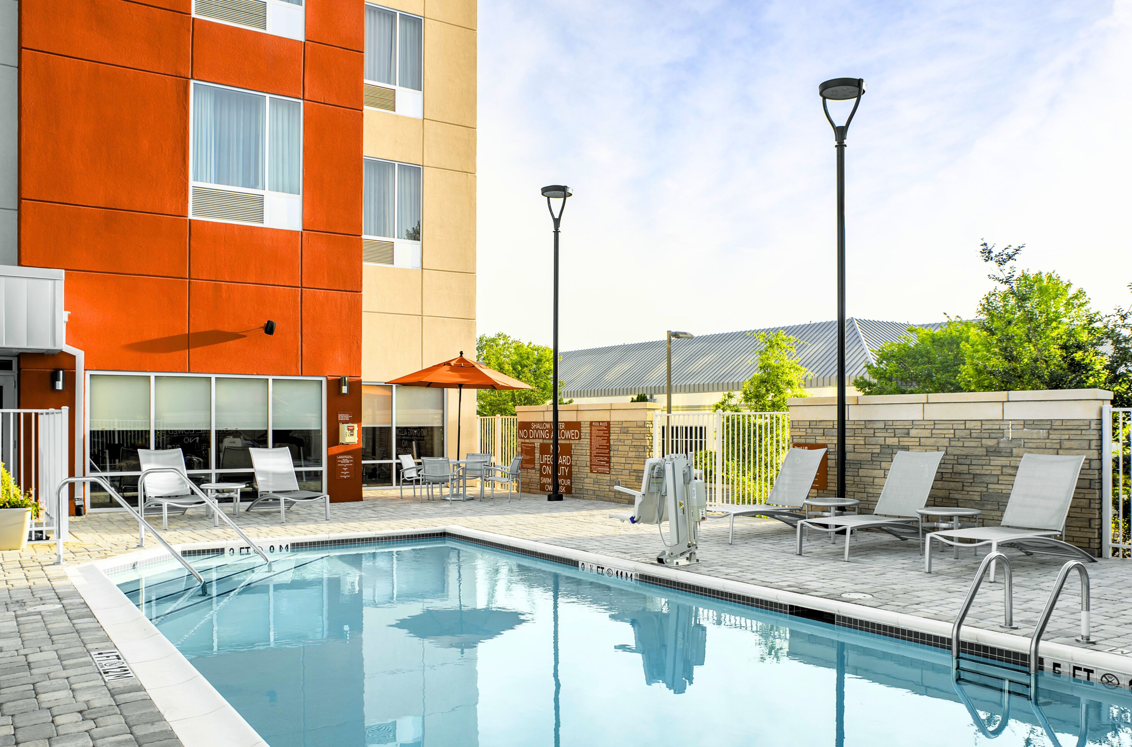 Seasonal outdoor pool, open 9:00 AM to 10:00 PM, pool umbrellas