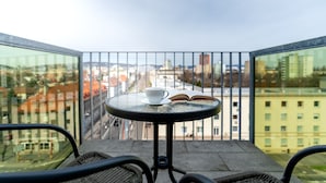 A balcony with a round table, a cup, and an open book. - Apollis Business & Budget by Ambiente (Bratislava)