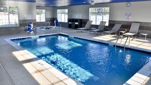 An indoor swimming pool with clear water, marked depth lines, and lounge chairs around the perimeter. - Microtel Inn & Suites by Wyndham Lubbock (Lubbock)