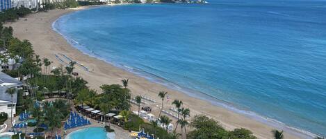 A resort with a pool, beach, and ocean view.