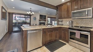 A modern kitchen with wooden cabinets, stainless steel appliances, and a large island. - Mammoth Condo, 2 Beds+ 2 Baths, Next To Canyon Lodge-Mammoth Ski & Racquet Club (Mammoth Lakes)