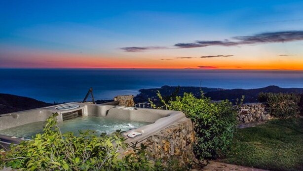 A hot tub with a view of the ocean at sunset. - Private Vineyard Estate Overlooking Pacific Ocean (Malibu)