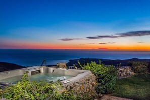 A hot tub with a view of the ocean at sunset. - Private Vineyard Estate Overlooking Pacific Ocean (Malibu)