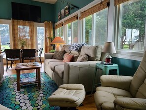 A cozy living room with a sofa, chairs, a coffee table, and a patterned rug. - 4 Bedroom Waterview - MD Chesapeake Bay! Walk to Marina, Beach Bar & Restaurant! (Stevensville)