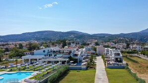 A resort with a swimming pool, multiple guest buildings, and a view of the surrounding landscape. - Blue oyster Beachfront villa, No car needed 1 (Rethymno)