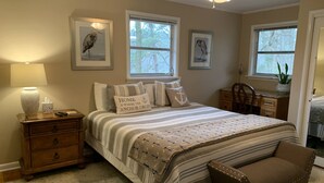 A bedroom with a bed, bedside table, lamp, and two windows. - Quiet, Charming Lake Front Home with Kayaks, 2 Guest Maximum (Hot Springs)