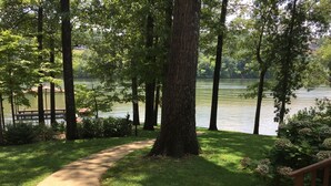 A pathway leading to a lake surrounded by trees and greenery. - Quiet, Charming Lake Front Home with Kayaks, 2 Guest Maximum (Hot Springs)