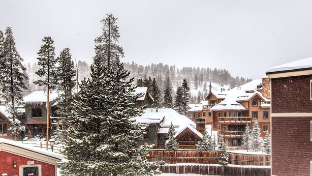 A snow-covered lodge with multiple buildings, surrounded by tall pine trees. - Best Location in Town -- One Block to Main St. & Close to the Slopes and Gondola (Breckenridge)