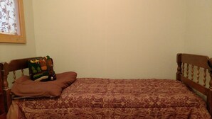 A small, single-bed room with a wooden headboard and footboard. -  A Little Piece Of Heaven (Brownville)