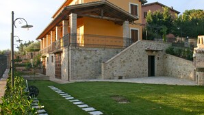 A stone building with a balcony and a small entrance. - Old Country House and pool In Umbrian Hills Between Foligno And Assisi (Foligno)