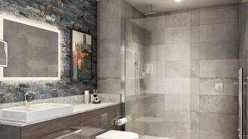 Un baño moderno con pared de piedra, un espejo grande, un lavamanos blanco, un inodoro y una ducha con cerramiento de vidrio.
