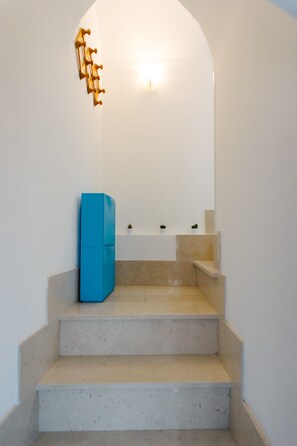 Stairs lead to a second-floor area with a clean, minimalist design.