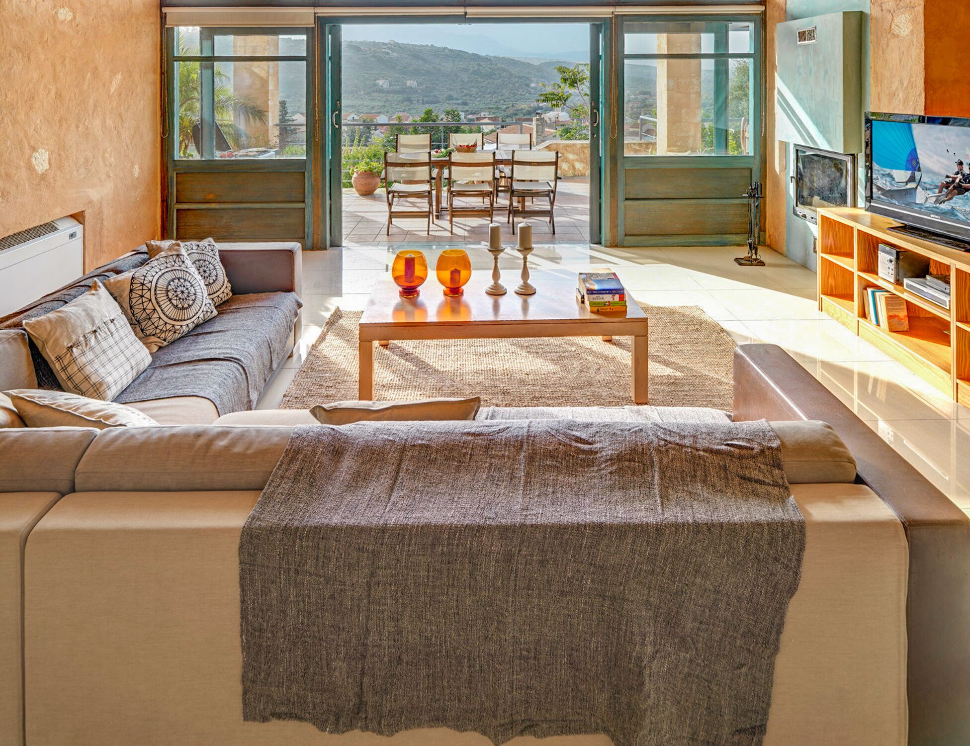 A modern living room with a sofa, coffee table, and TV area.