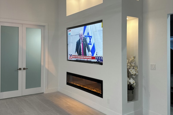 Tv Room 85 inch Tv and Fire Place