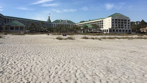 A beachfront hotel with multiple buildings, a sandy beach, and a clear sky. - Ocean Palms-Heaven is Being At The Beach-Free Golf/Tennis (Hilton Head Island)