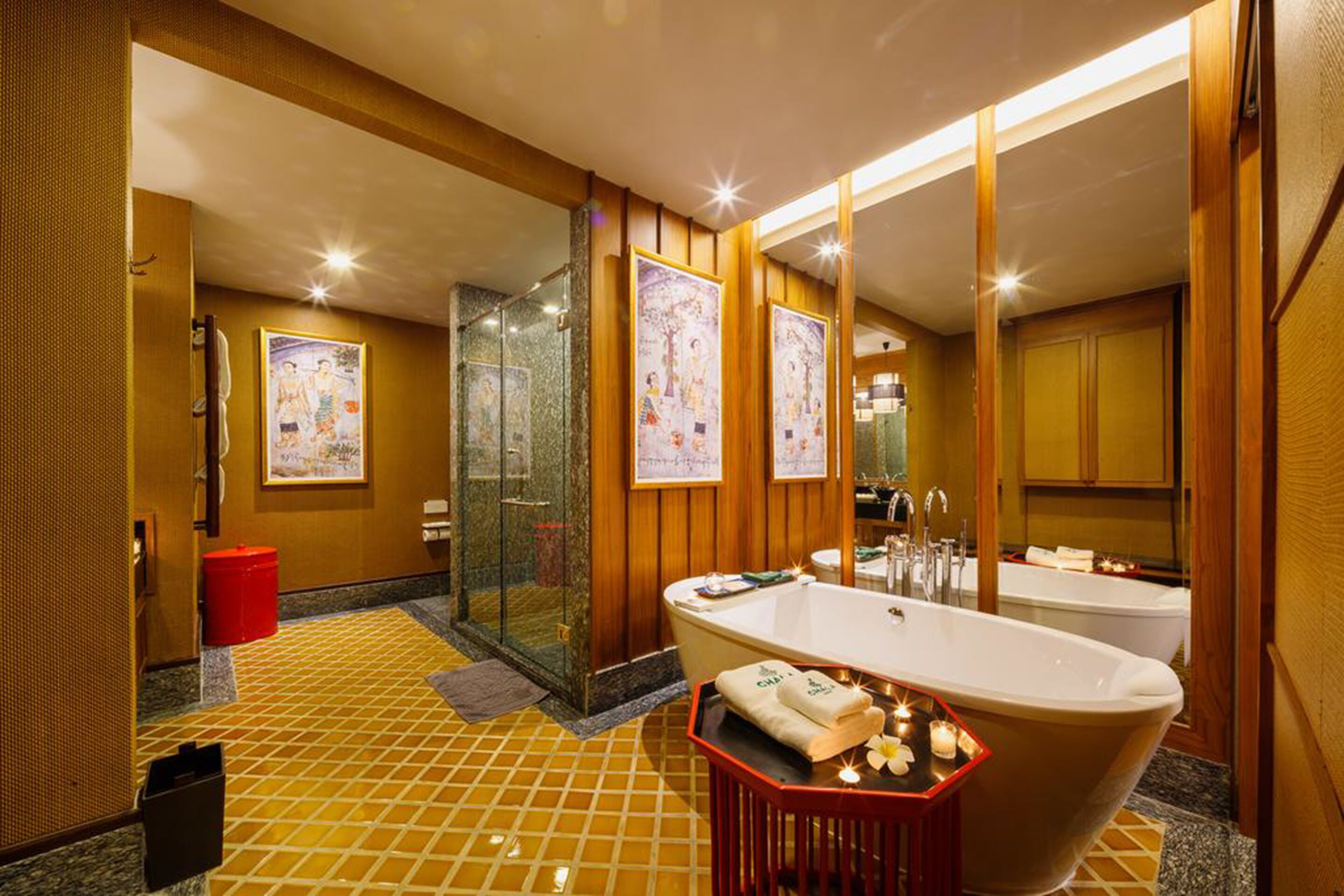 A modern bathroom with a freestanding bathtub, a glass-enclosed shower, and wooden paneling.