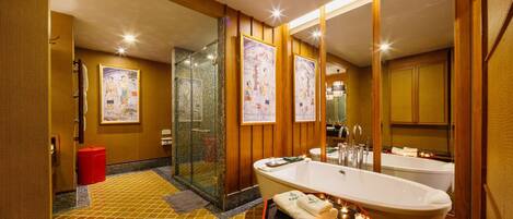 A modern bathroom with a freestanding bathtub, a glass-enclosed shower, and wooden paneling.
