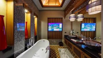 A modern bathroom with a freestanding bathtub, dual sinks, and a large mirror.