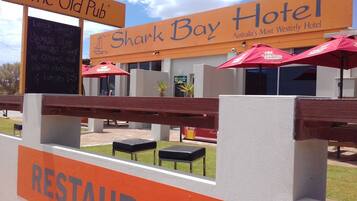 Enjoy a meal at The Old Pub, adjacent to Shark Bay Hotel, with outdoor seating and a modern design.