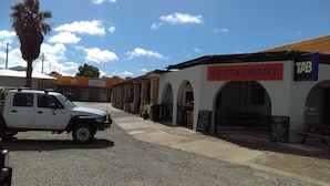 A white van parked in front of a building with a 'RESTAURANT' sign. - Shark Bay Hotel (Denham)