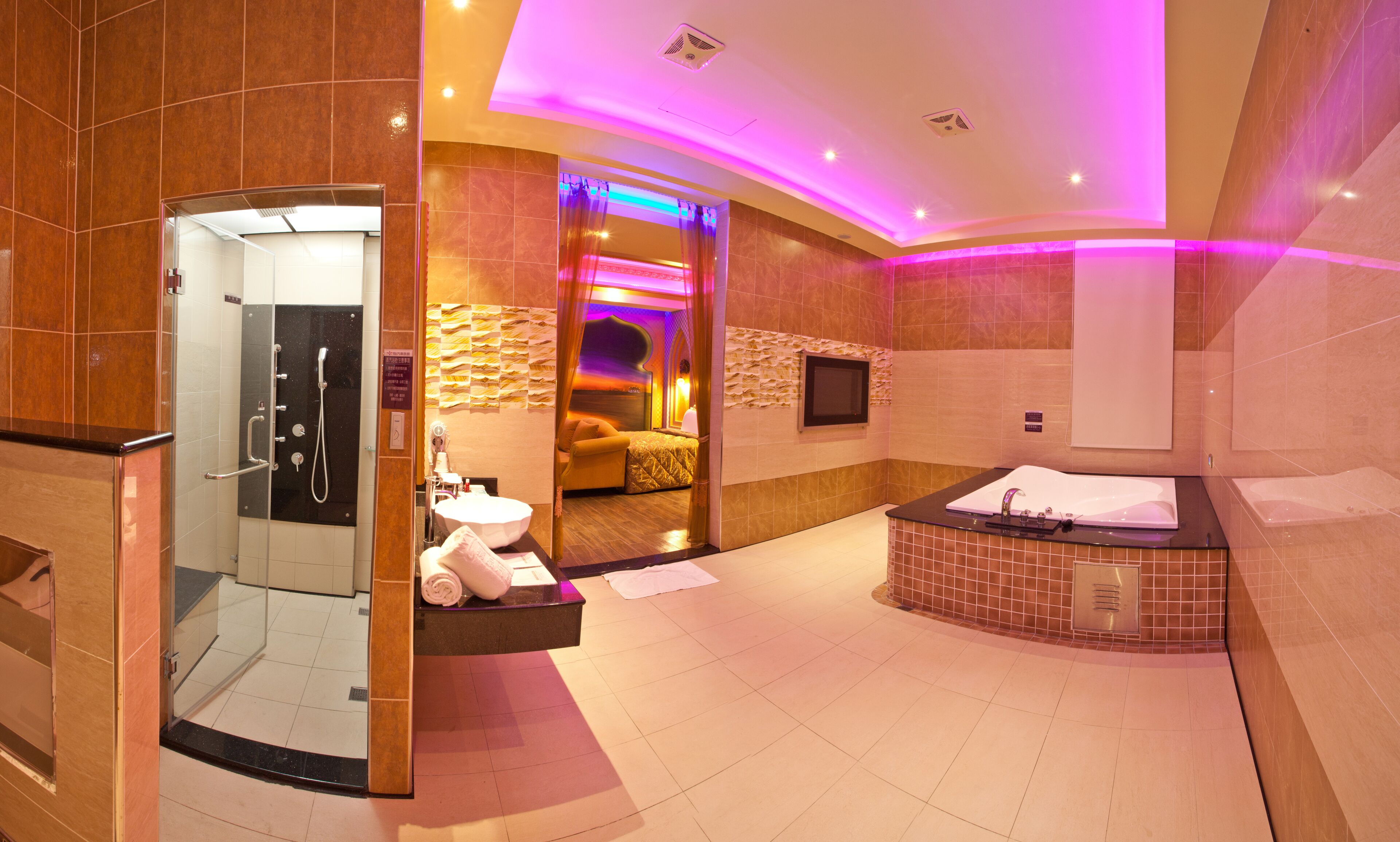 A modern bathroom with a glass-enclosed shower, a large bathtub, and a separate toilet area.