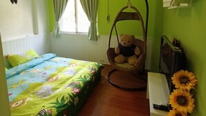 A room with a bed, a hanging chair, a small table, and a wall-mounted air conditioner. - Shuili Heti (Shuili)