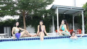 Three individuals by a swimming pool with a covered area and trees in the background. - Baan Pimsamai Pool Villa Hua Hin (Hua Hin)