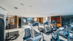 A gym with multiple treadmills, weight machines, and a variety of fitness equipment.