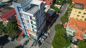 A multi-story building with a modern architectural design, featuring balconies and large windows. - Monorom Apartment Boeung Kang Keng 1 (Phnom Penh)
