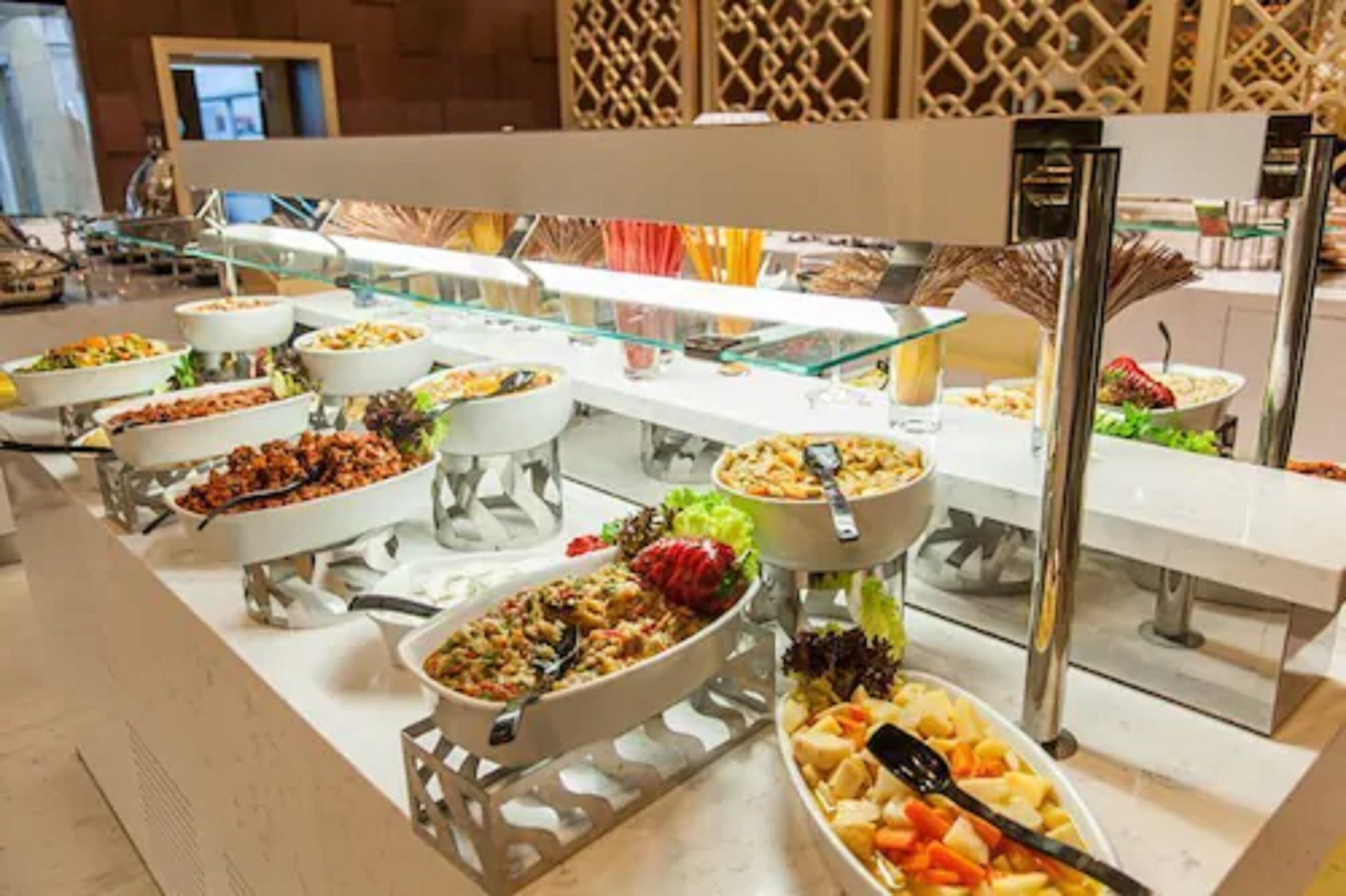 A buffet with various dishes and a glass display case.