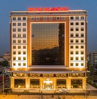 A multi-story hotel with a prominent 'BAYIR DIAMOND' sign at the top.