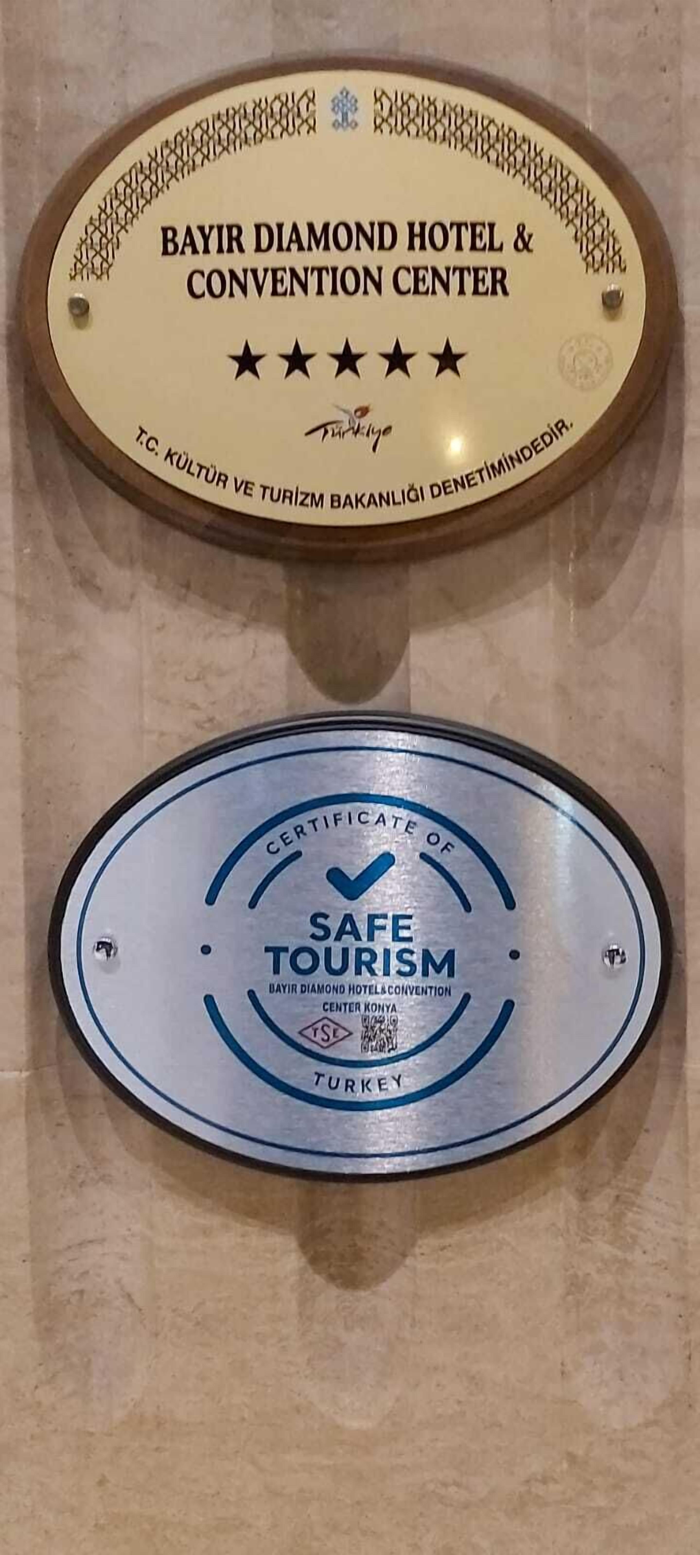 Two plaques: one for the Bayir Diamond Hotel & Convention Center and another for Safe Tourism certification.